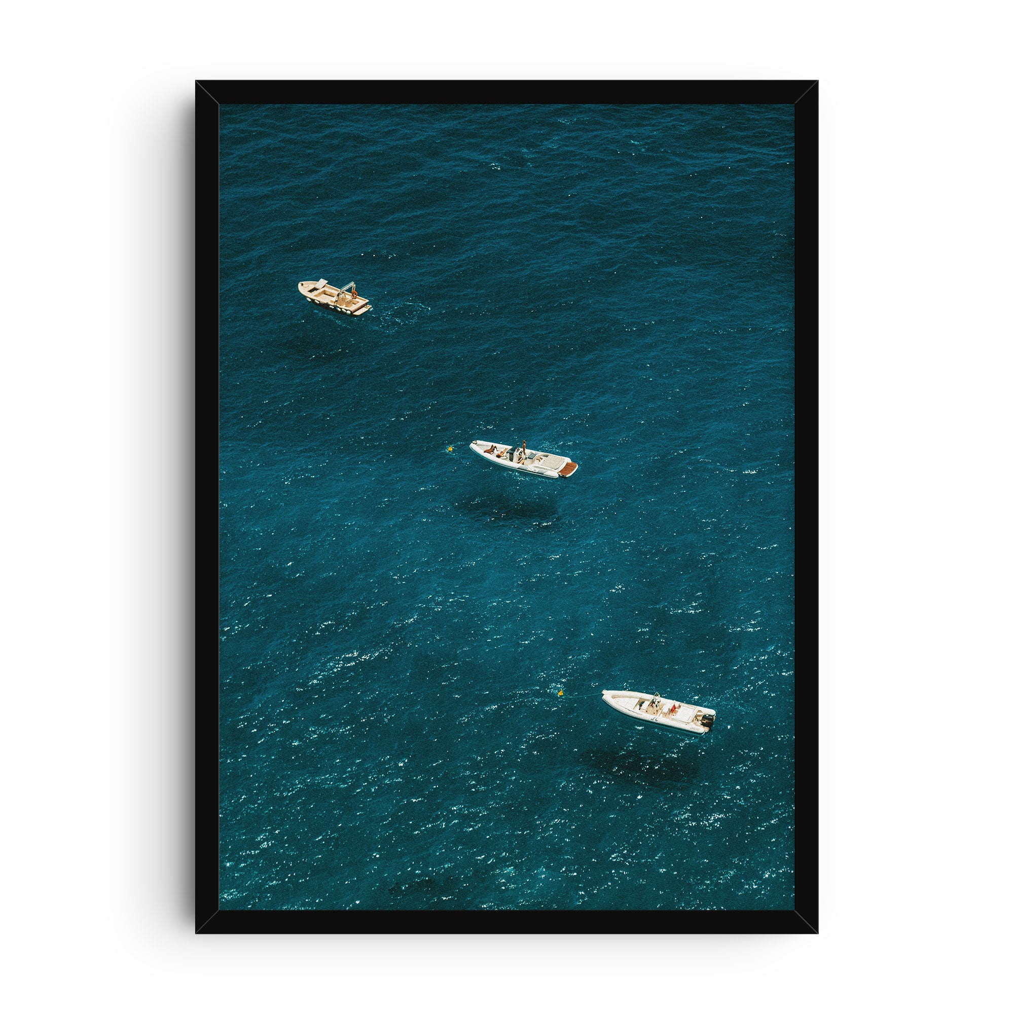 Photographic art print showing three boats floating on the shimmering deep blue waters of the Amalfi Coast. The vibrant Mediterranean seascape captures turquoise textures and sunny reflections, evoking summer travel and coastal living.