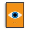 Bauhaus-inspired art print showing a large geometric eye with a blue iris and black pupil set against a vivid orange background. Below the design, the word “Bauhaus” appears in minimalist typography.