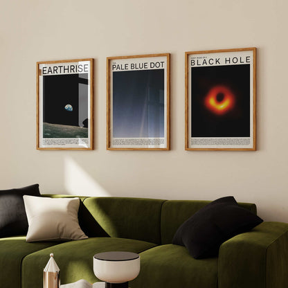 Space Photography Art Print Set featuring iconic images of Black Hole, Pale Blue Dot, and Earthrise, displayed in wooden frames hanging on a light-colored wall.